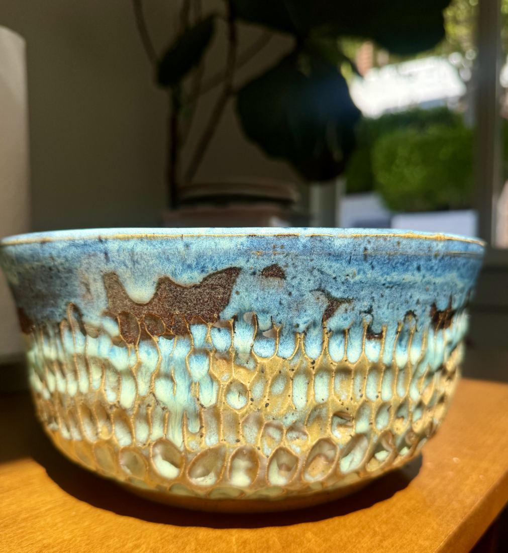 Bowl with a dimpled honey-glazed body and a blue rim