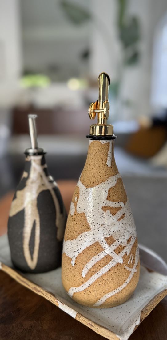 Oil pour bottles with white glaze on speckled clay, on a matching tray