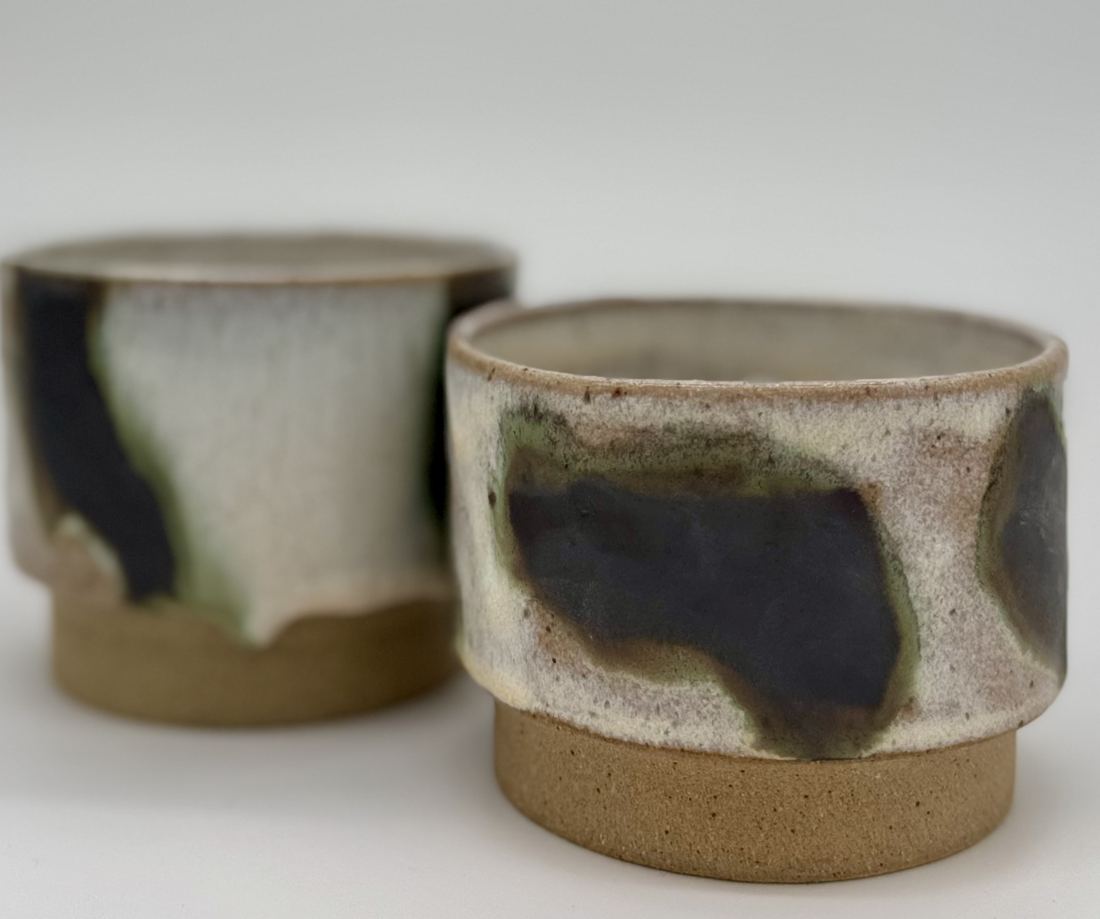 Two footed cups in white with ink-dark brushed glaze